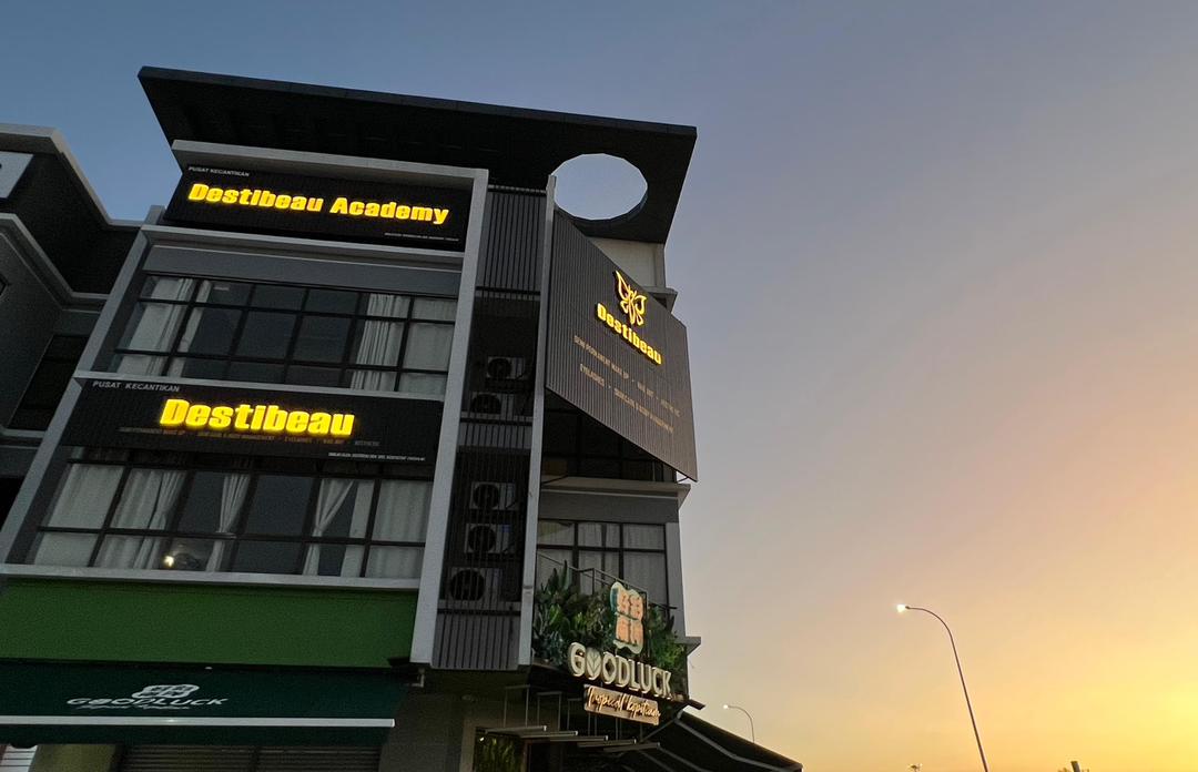 Destibeau beauty centre storefront and Destibeau Academy signage at Kepayang Sentral, Seremban, at dusk